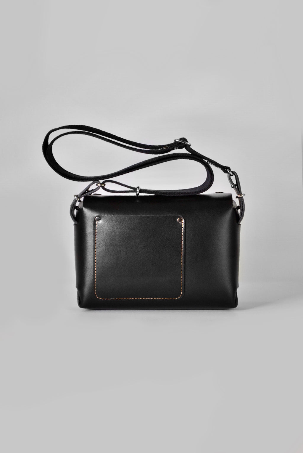 Black leather crossbody handbag with a cotton adjustable strap and silver hardware 