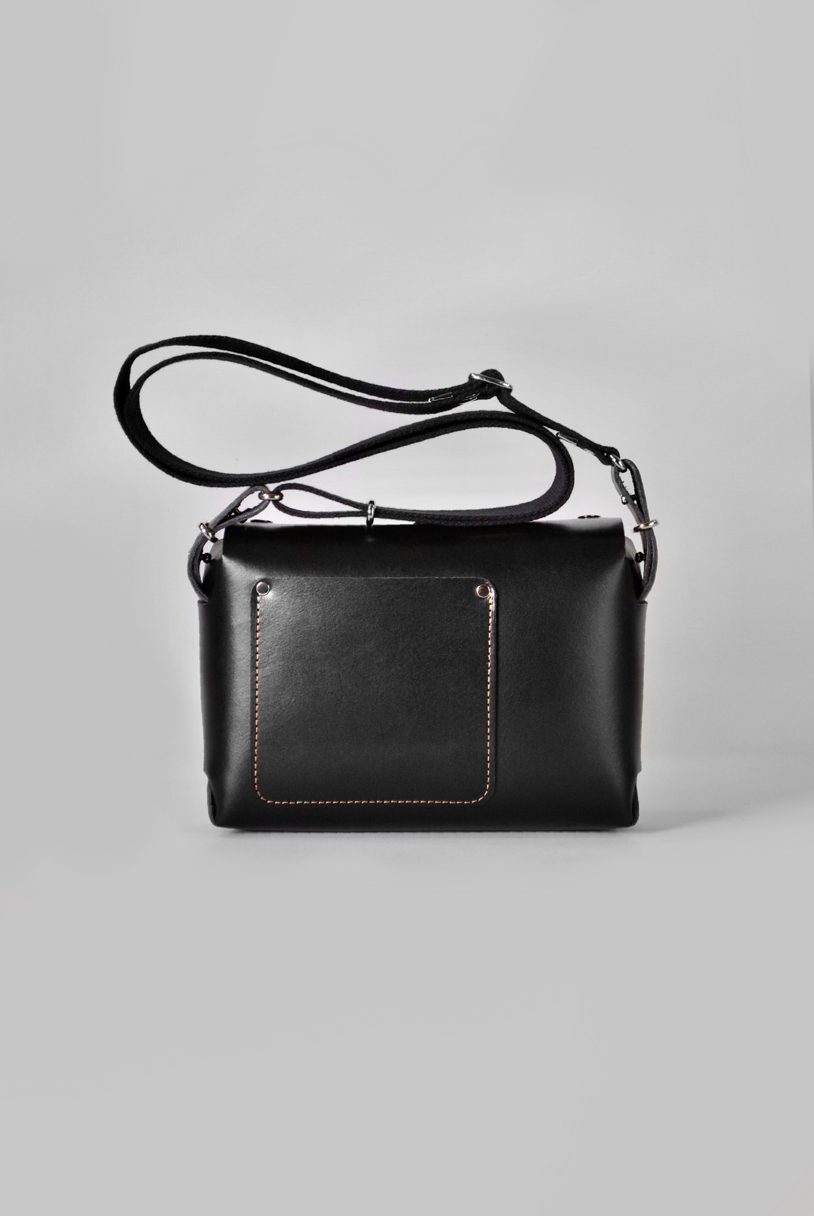Black leather crossbody handbag with a cotton adjustable strap and silver hardware 
